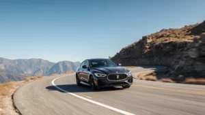 Professional automotive photographer testing luxury sedan on winding mountain road with clear sky, demonstrating handling and performance capabilities