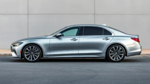 2024 luxury sedan sleek profile view silver paint metallic finish modern design lines parked elegantly professional automotive photography