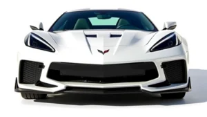 2024 Chevrolet Corvette Z06 in Arctic White, photographed from three-quarter front angle in bright daylight, showing aggressive front fascia and muscular body lines, professional automotive studio setting
