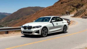 2024 BMW 340i luxury sports sedan, pearl white exterior, photographed from three-quarter front angle on a winding mountain road with clear sky, professional automotive photography