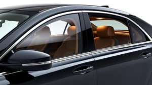 High-end luxury sedan with sleek design, premium leather interior visible through windows, polished chrome details, professional automotive photography, studio lighting