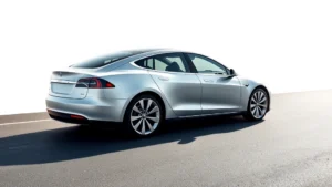 Sleek silver Tesla Model S photographed from three-quarter angle on smooth asphalt, modern minimalist aesthetic, daylight professional automotive photography, isolated white background