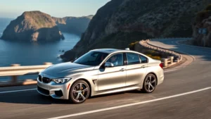 Sleek silver BMW M440i xDrive sedan on winding mountain road with dramatic coastal cliffs background, professional automotive photography, dynamic angle