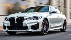 2024 BMW M440i xDrive sedan front three-quarter view, white pearl finish, aggressive sport styling, blurred motion background