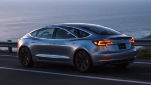 Tesla Model 3 Performance electric sedan in midnight silver, sleek profile on coastal highway with ocean backdrop, dynamic lighting highlighting aerodynamic curves